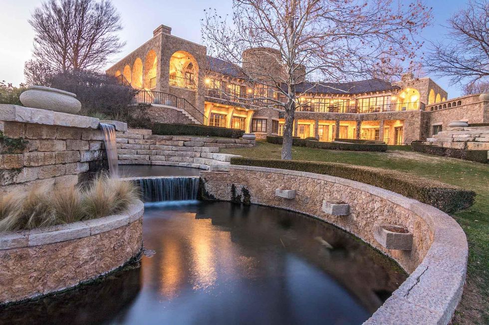 One of the waterfalls attached to the creek with the main house in the background.