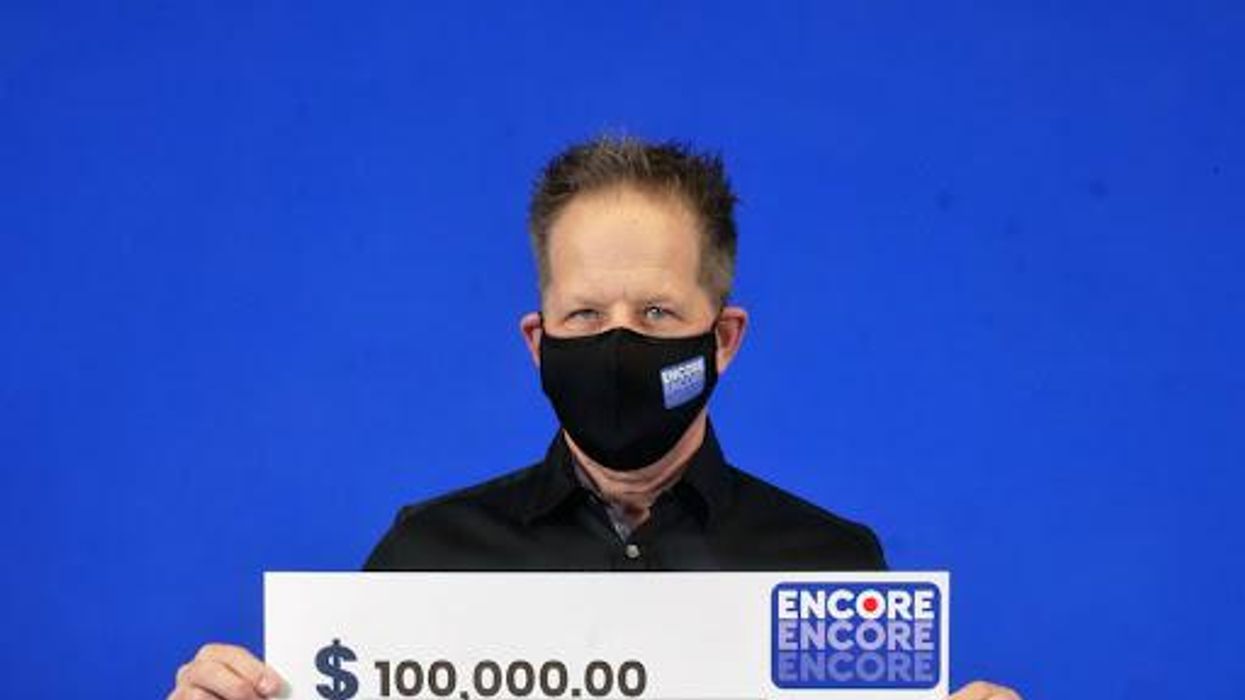 Ontario lottery winner Glen Harper picking up his winning in Toronto.