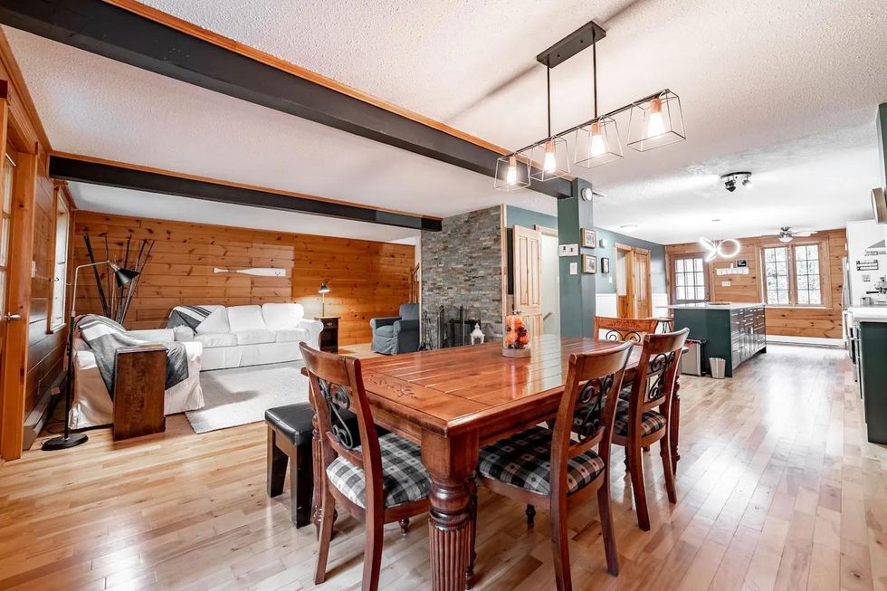 Open concept chalet Airbnb with a living room and spacious farmhouse kitchen.