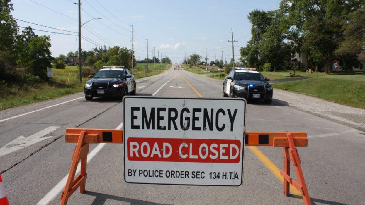 OPP on scene behind a 'Emergency Road Closed' sign.