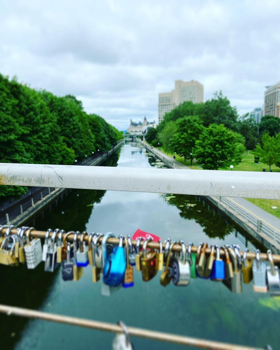 Ottawa's love lock bridge overlooking the Rideau Canal and Fairmont Chateau Laurier.