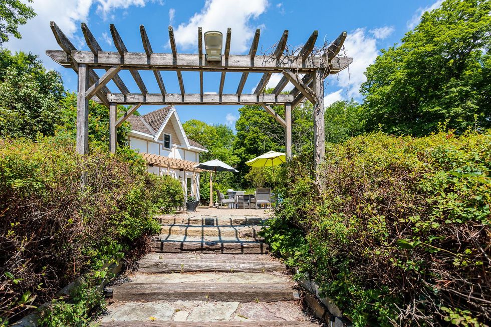 Outdoor walkway to coach house and pool area at Ontario home.