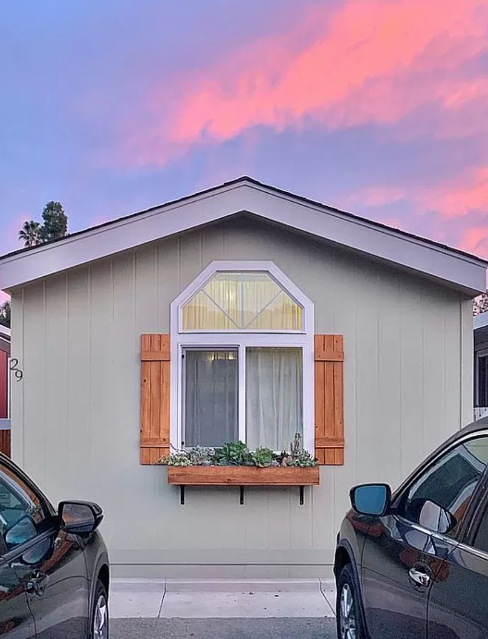 Outside of home with two parked cars.