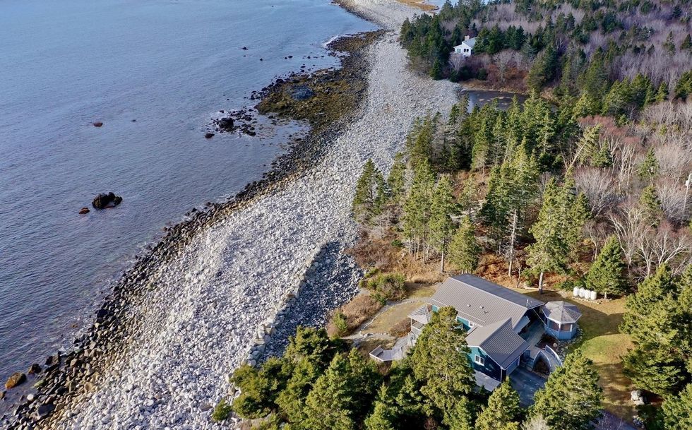 overhead view of the house, the stone beach and the ocean