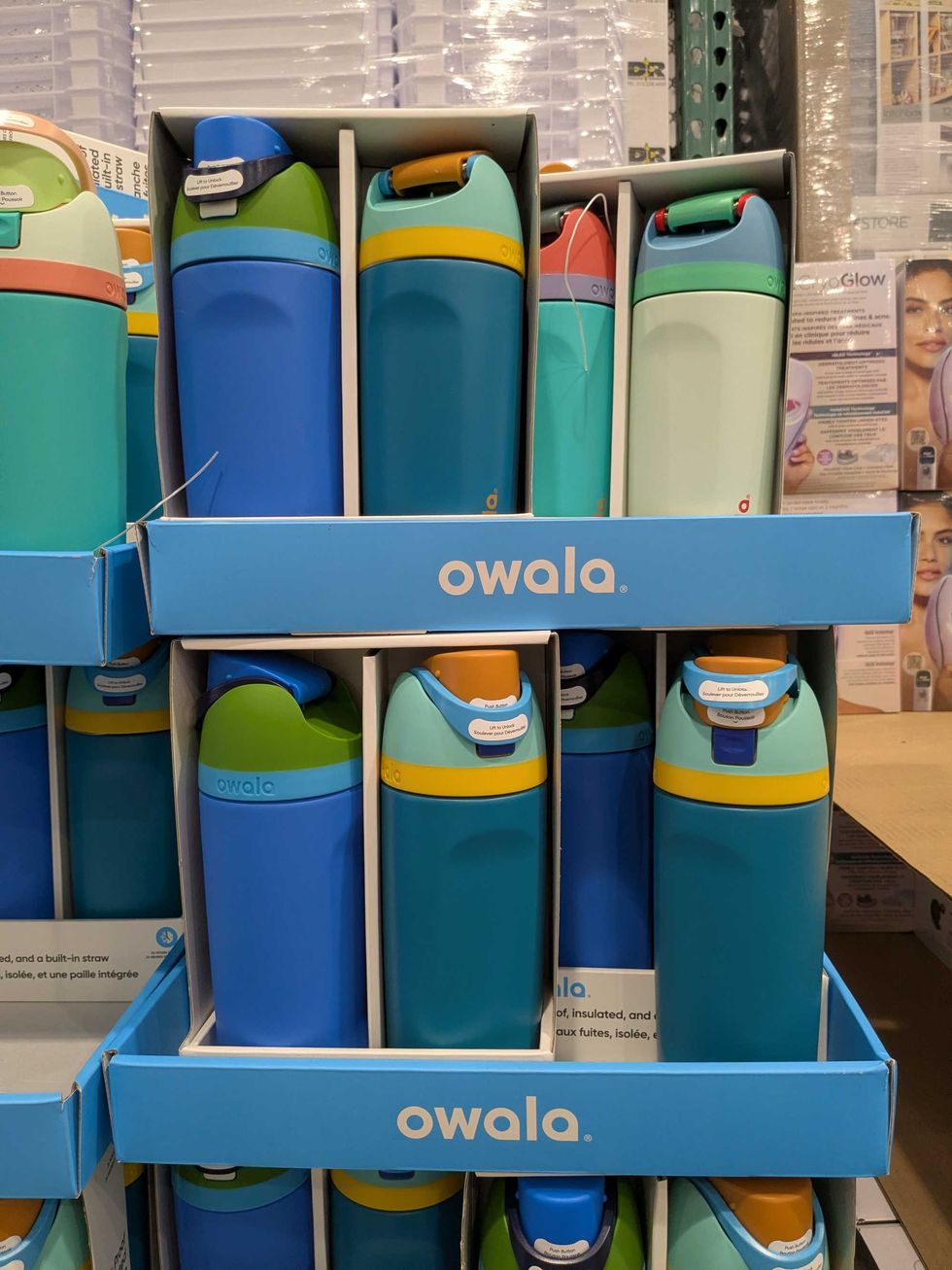 Owala water bottles stacked in boxes