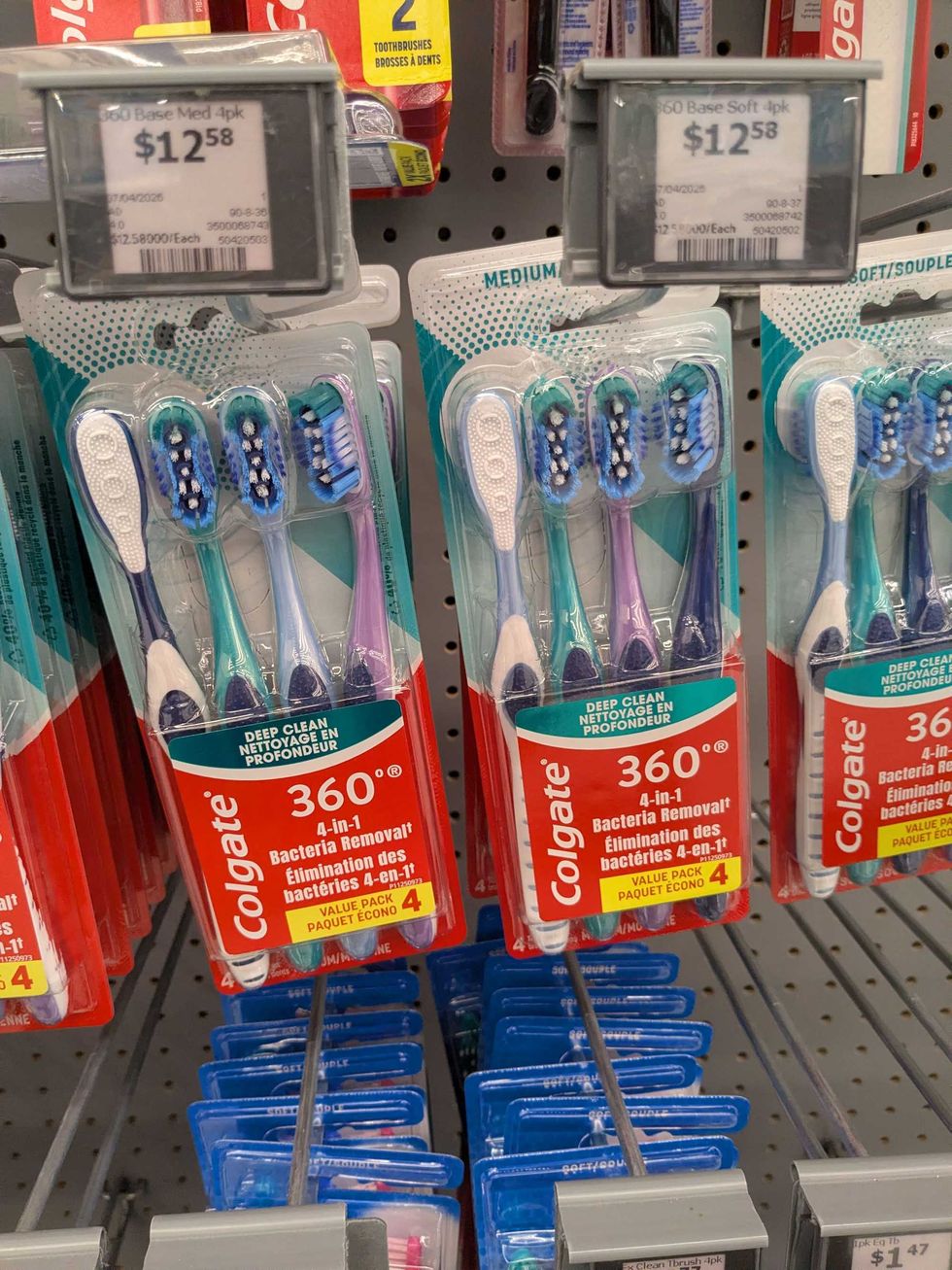 Packages of toothbrushes hanging on a shelf