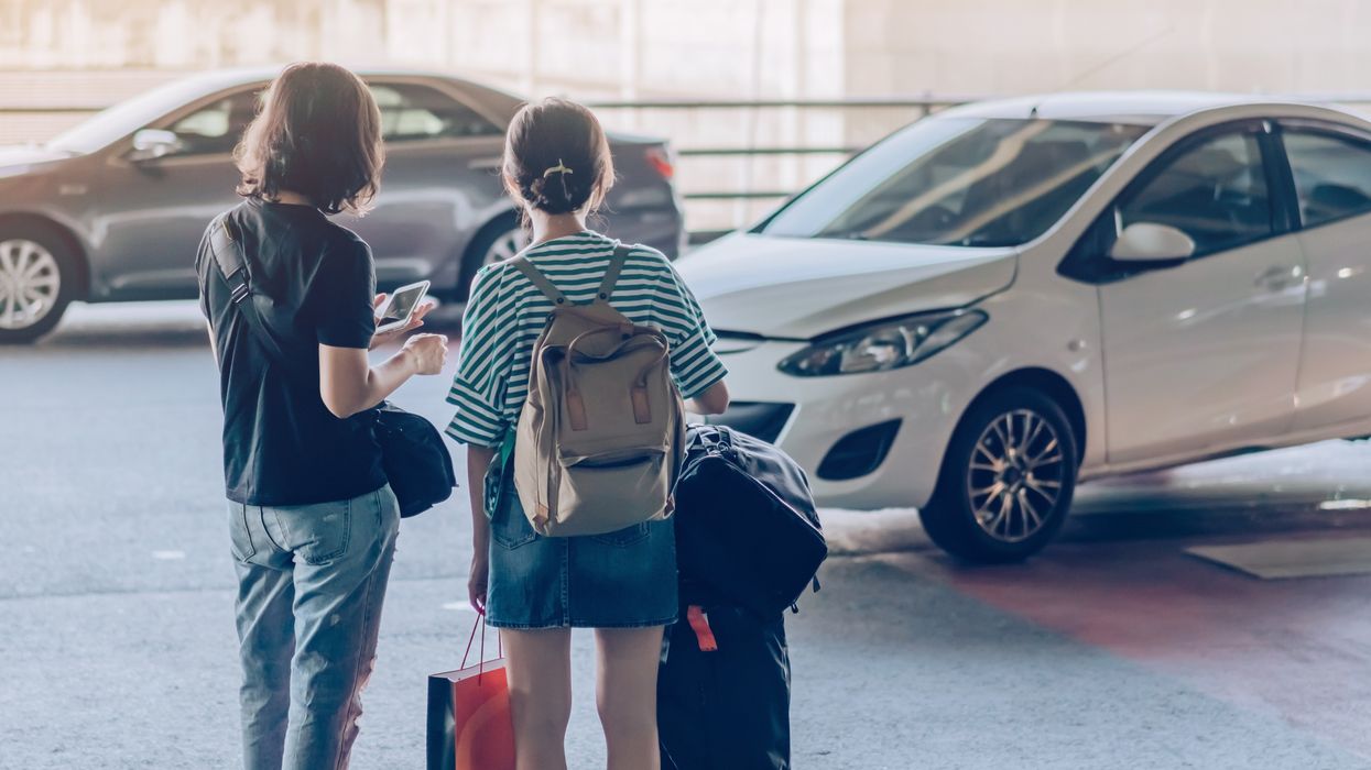 Passengers at an airport pick-up area.