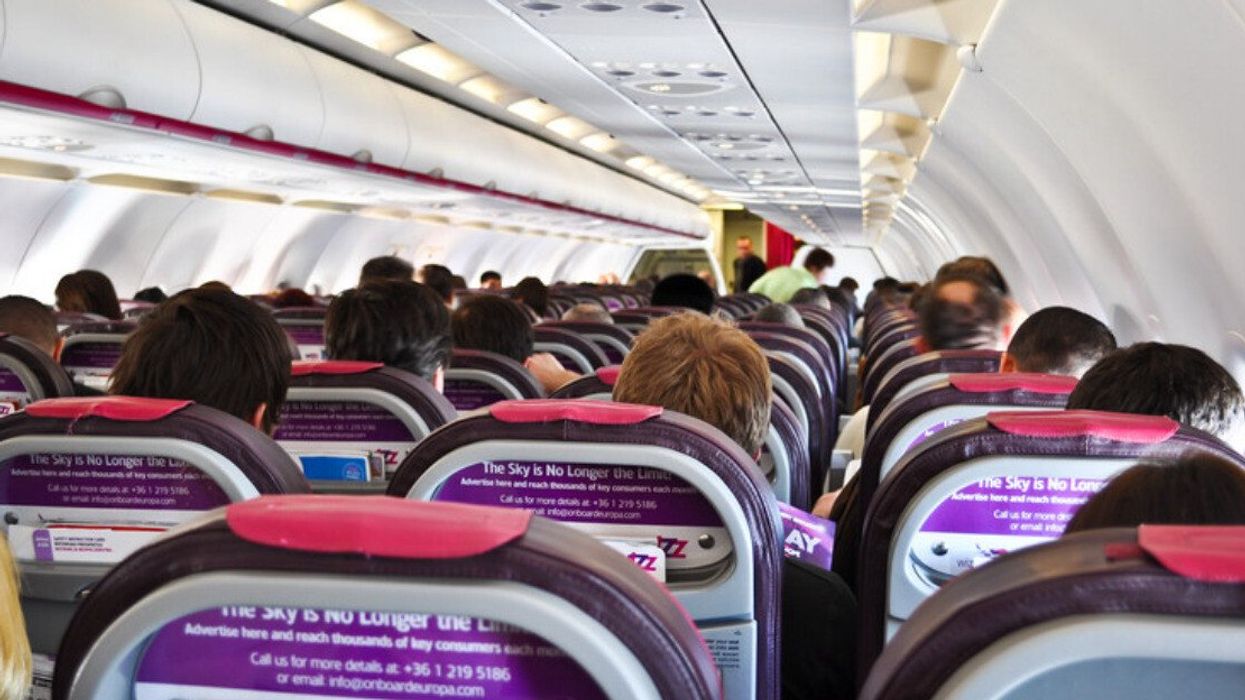 Passengers sitting inside an airplane.
