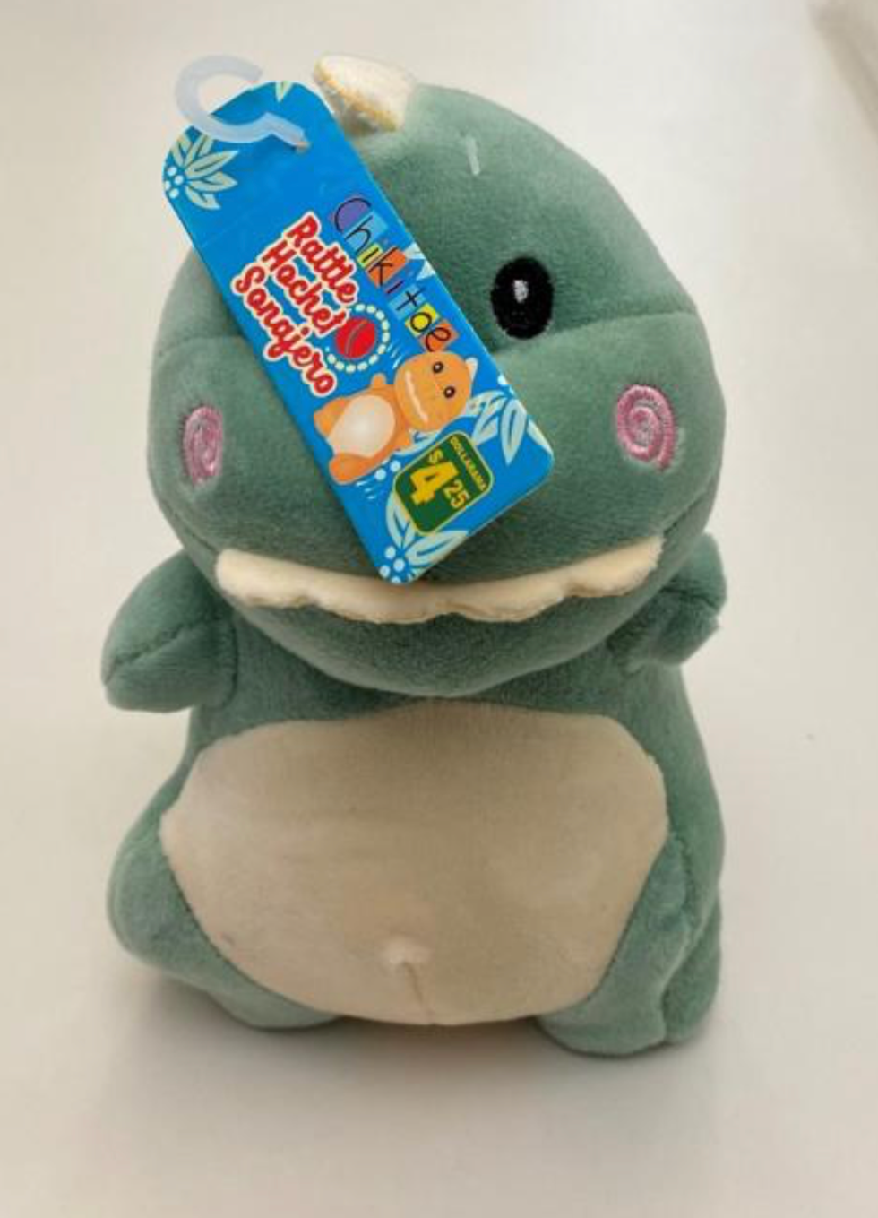 Peluche en forme de dinosaure.