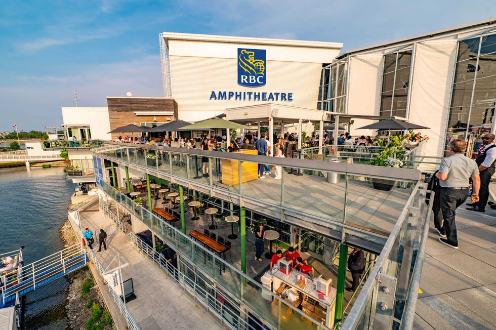 People gathered on the RBC Amphitheatre terrace overlooking Toronto's waterfront.