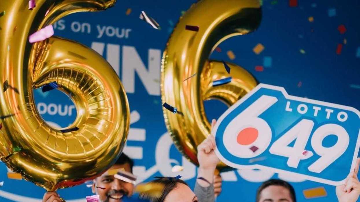 people holding lotto 6/49 sign and gold balloons