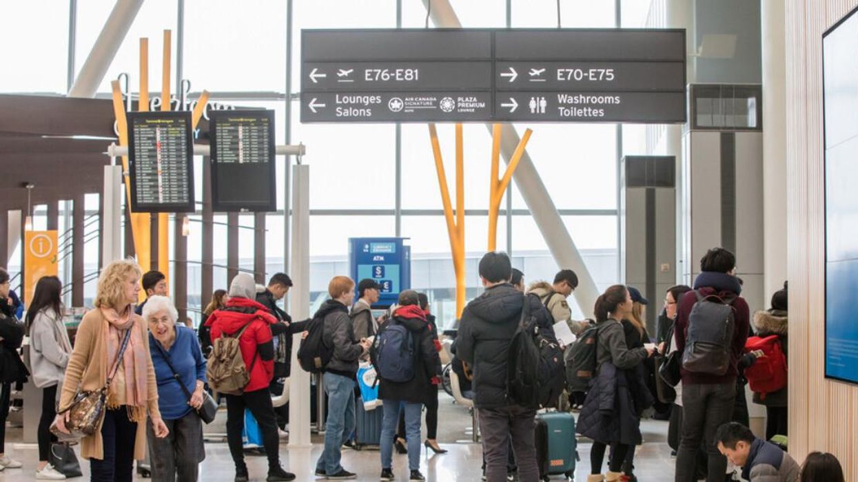 People inside a Toronto Pearson Airport terminal.