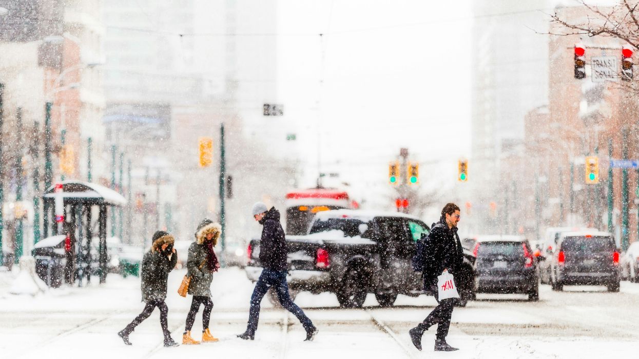 people on a toronto street while it snows
