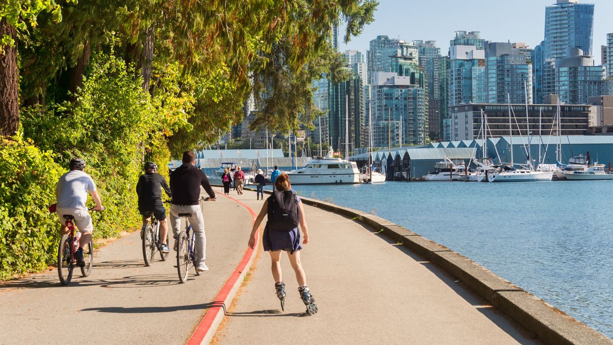 People roller skating and cycling in Stanley Park.
