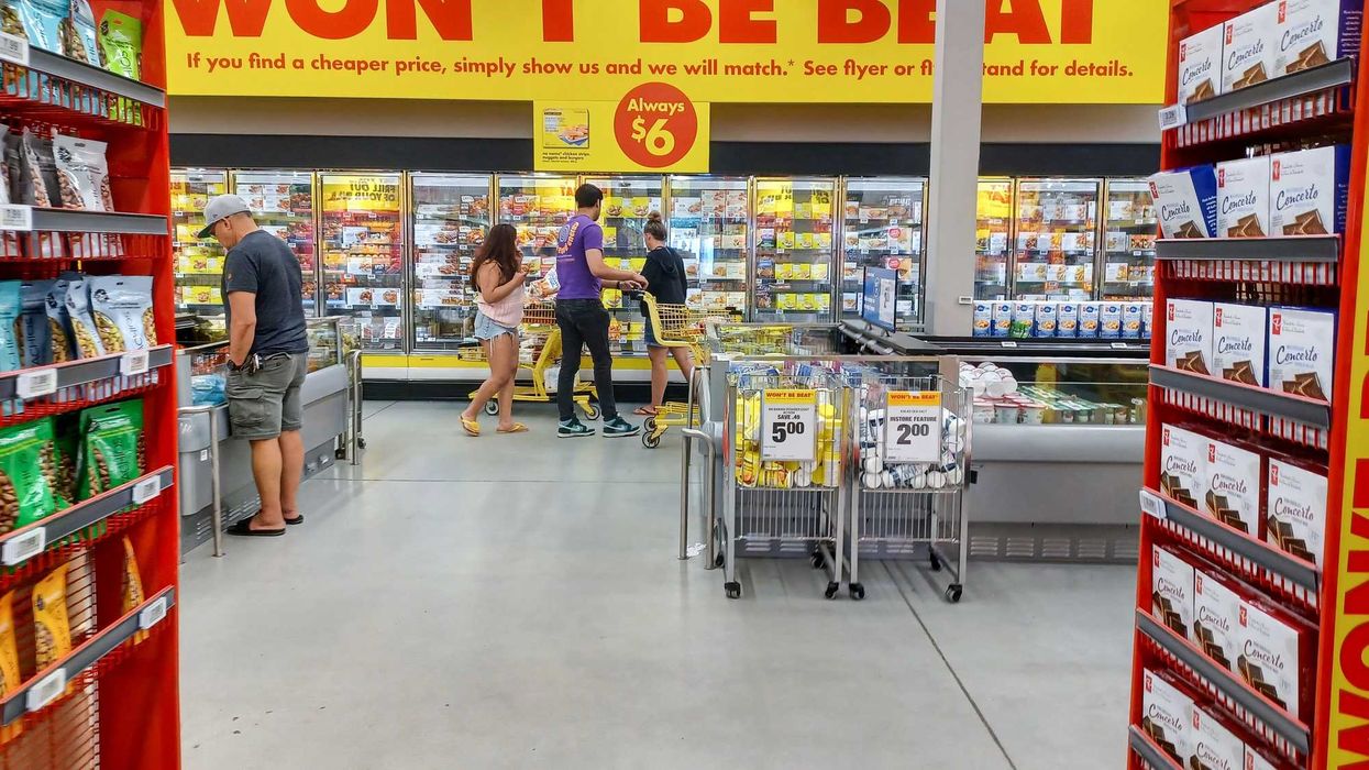 people shopping in the freezers with no name products at no frills store in canada