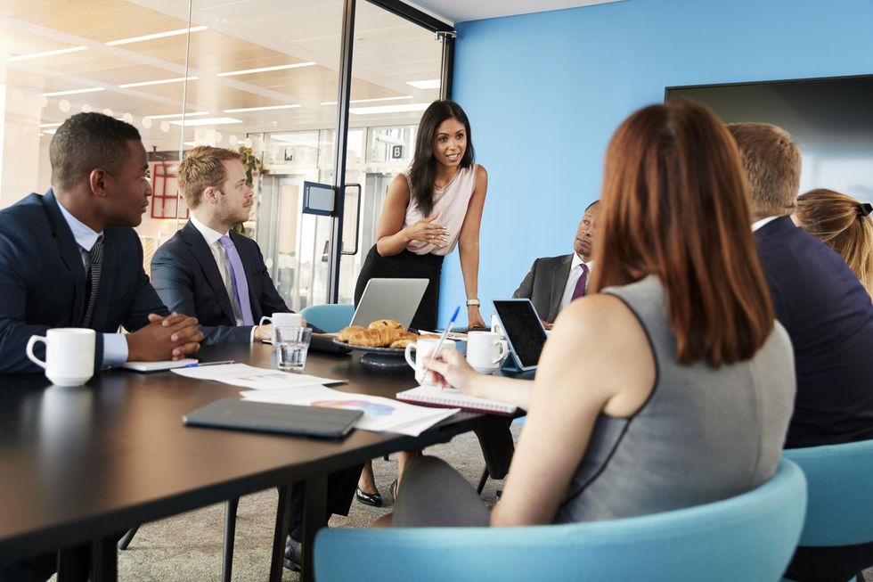 People sitting around a table in a meeting.