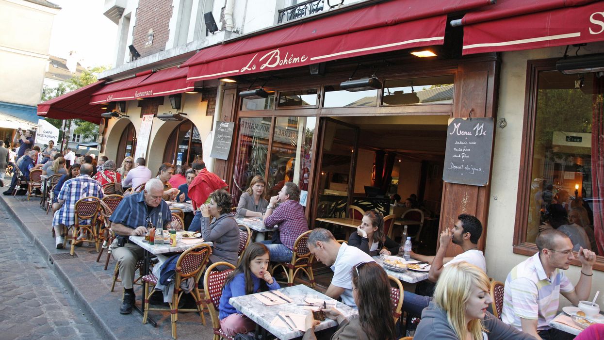 People sitting at a cafe in France.