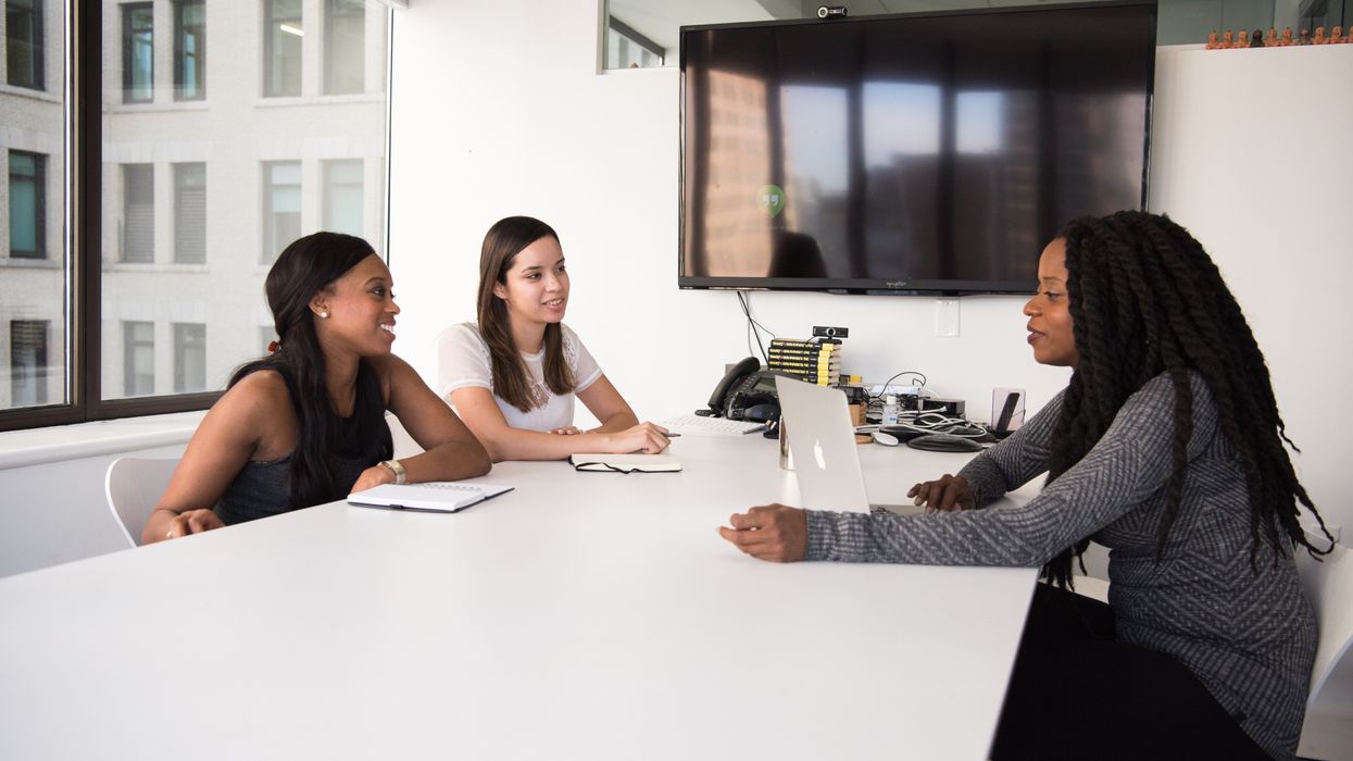 People sitting at a table in an office.