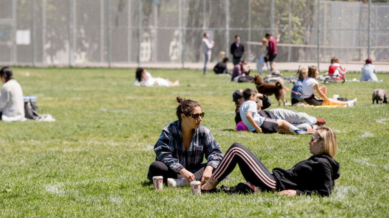 People sitting in Trinity Bellwoods Park.