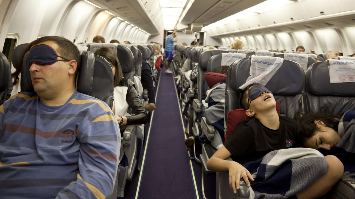 People sleeping on a flight.