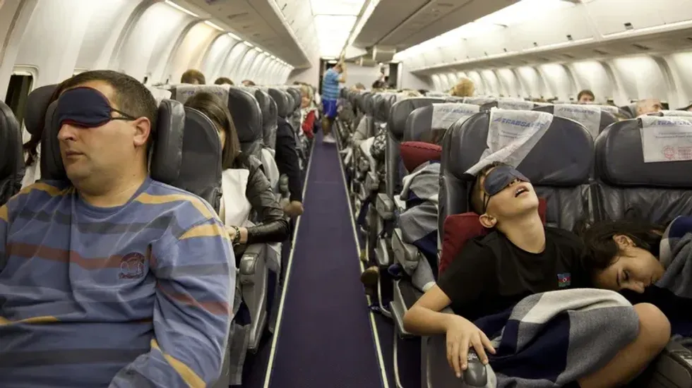 People sleeping on a flight.