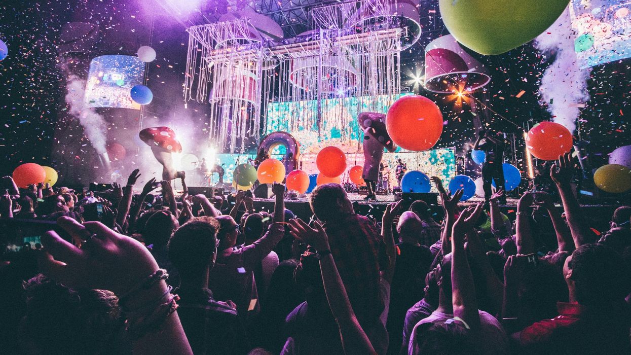 People stand in front of a stage.
