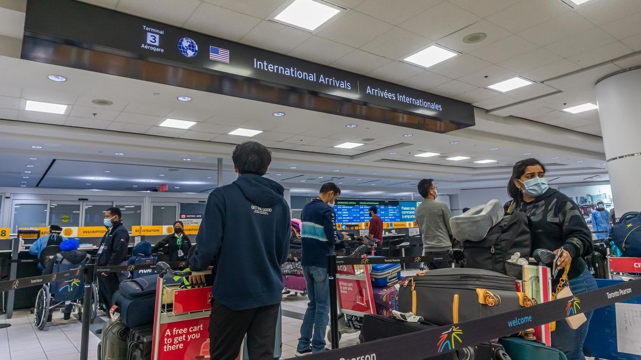 People waiting in line at Toronto Pearson Airport.