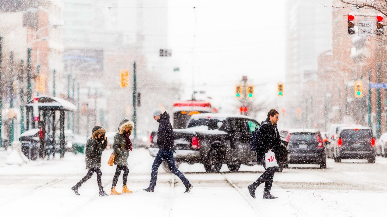 People walk in Toronto during a snowstorm.