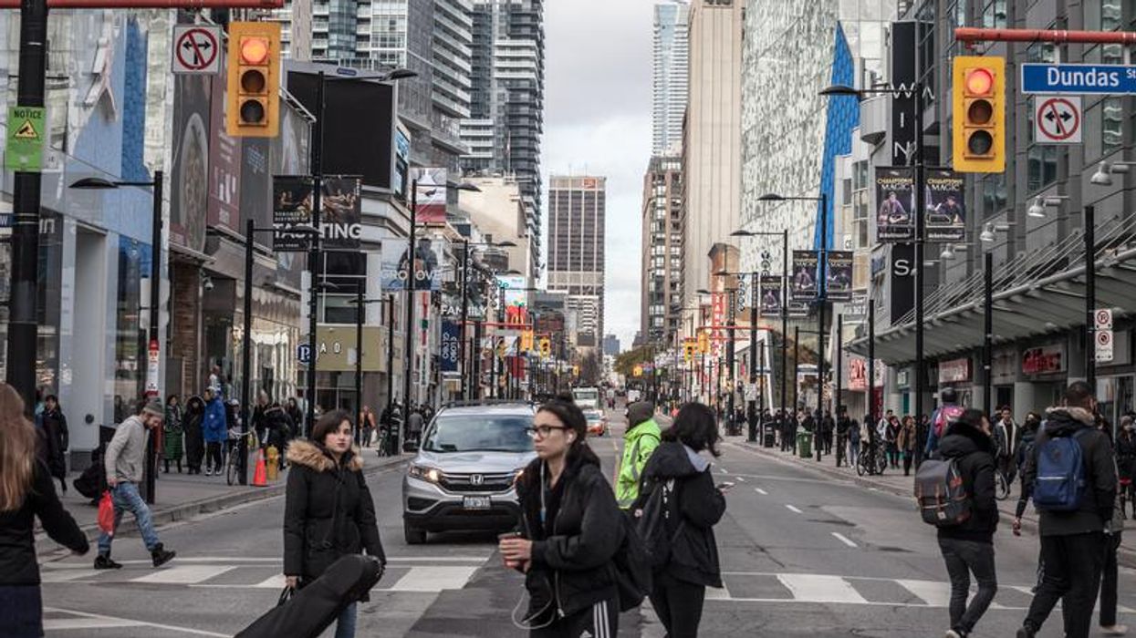 People walking around Yonge-Dundas in Toronto.