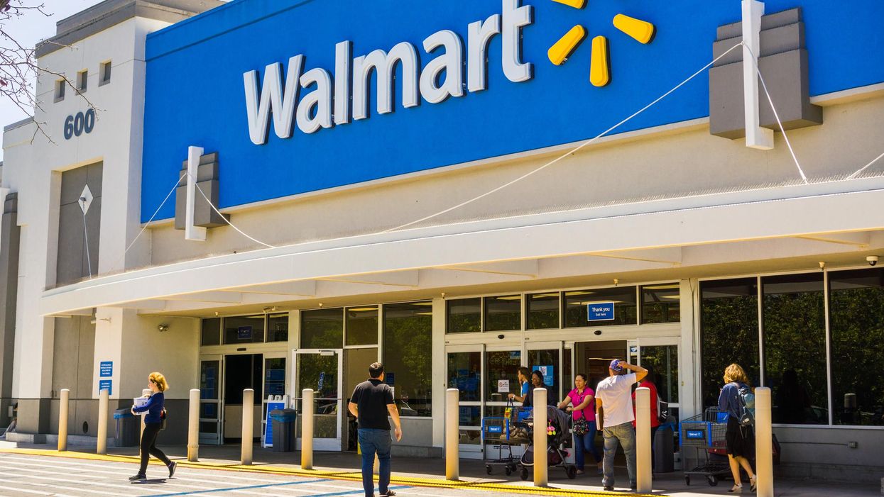 People walking in and out of a Walmart.