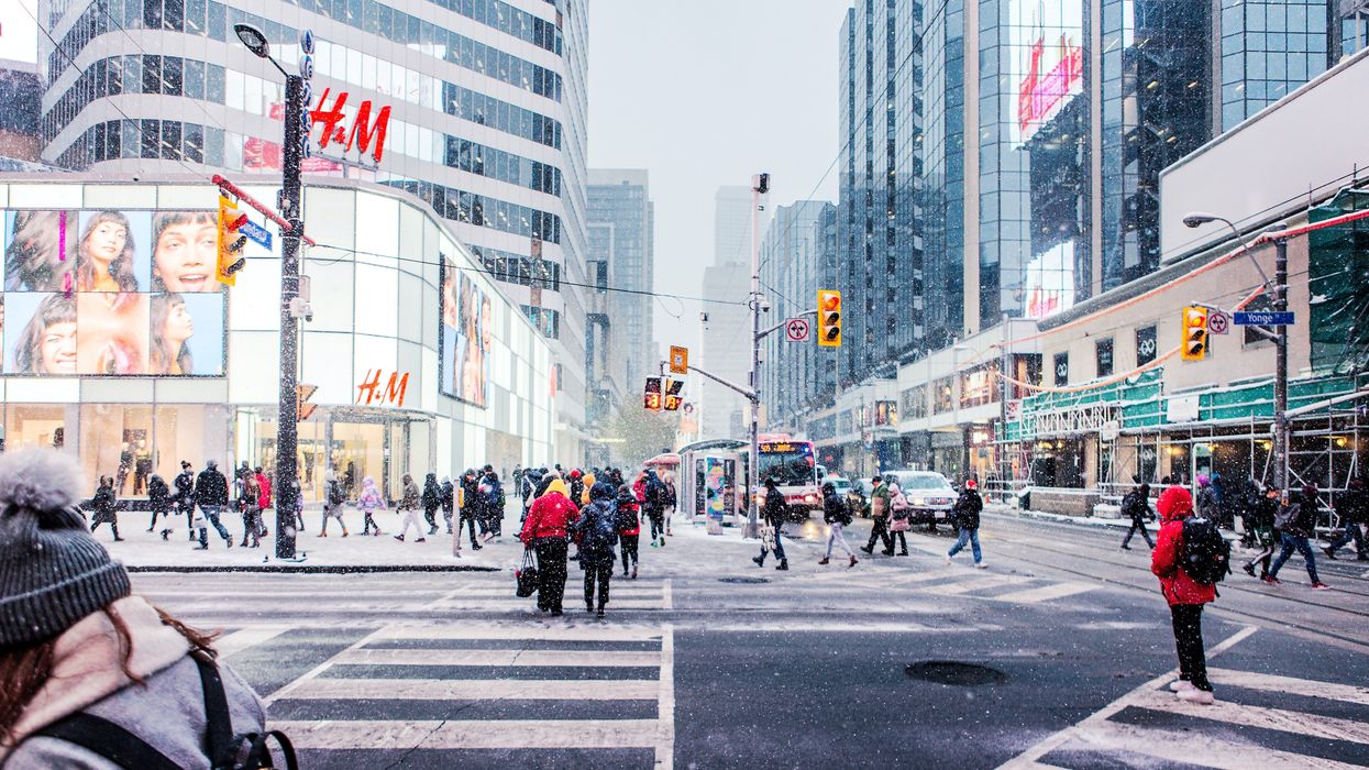people walking near toronto eaton centre while it's snowing