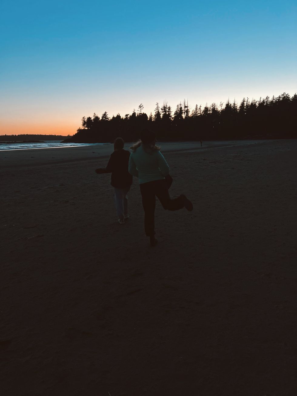 People walking on the beach in Tofino.