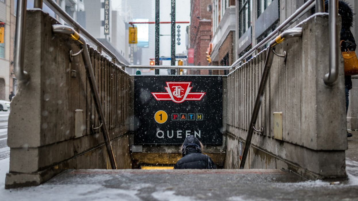 person going down the steps of a ttc subway entrance in toronto