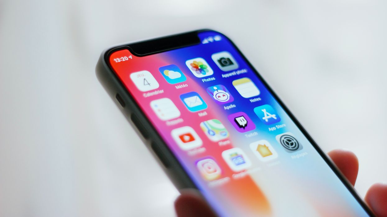 person holding a black apple iphone that's unlocked