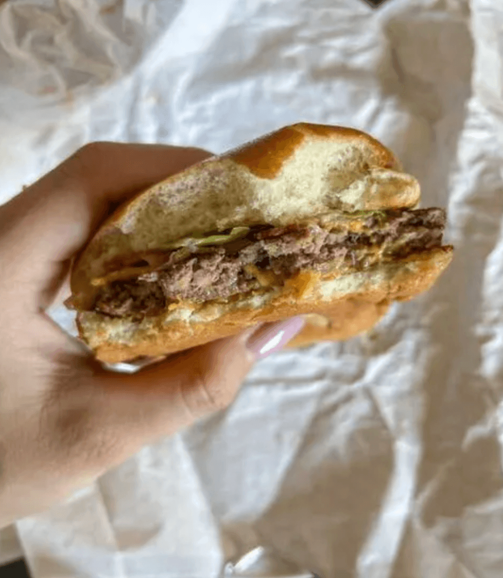 Person holding a burger