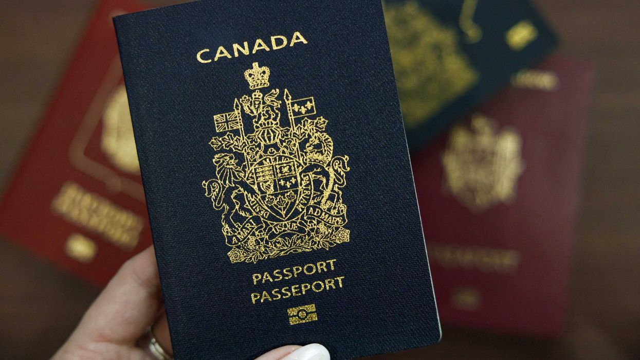person holding a canadian passport