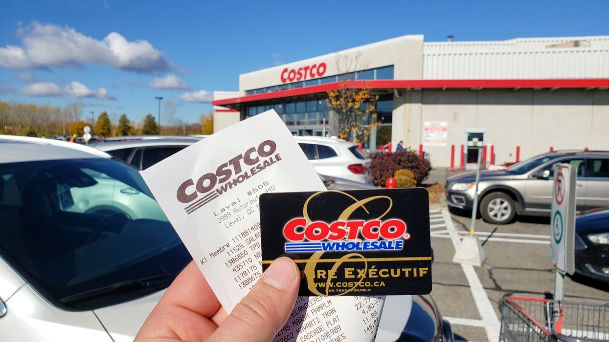 Person holding a Costco membership card and receipt in front of a Costco location in Montreal.