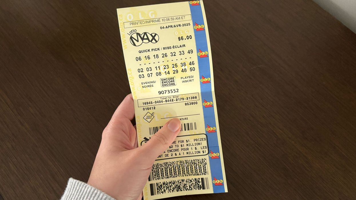 person holding a lotto max ticket
