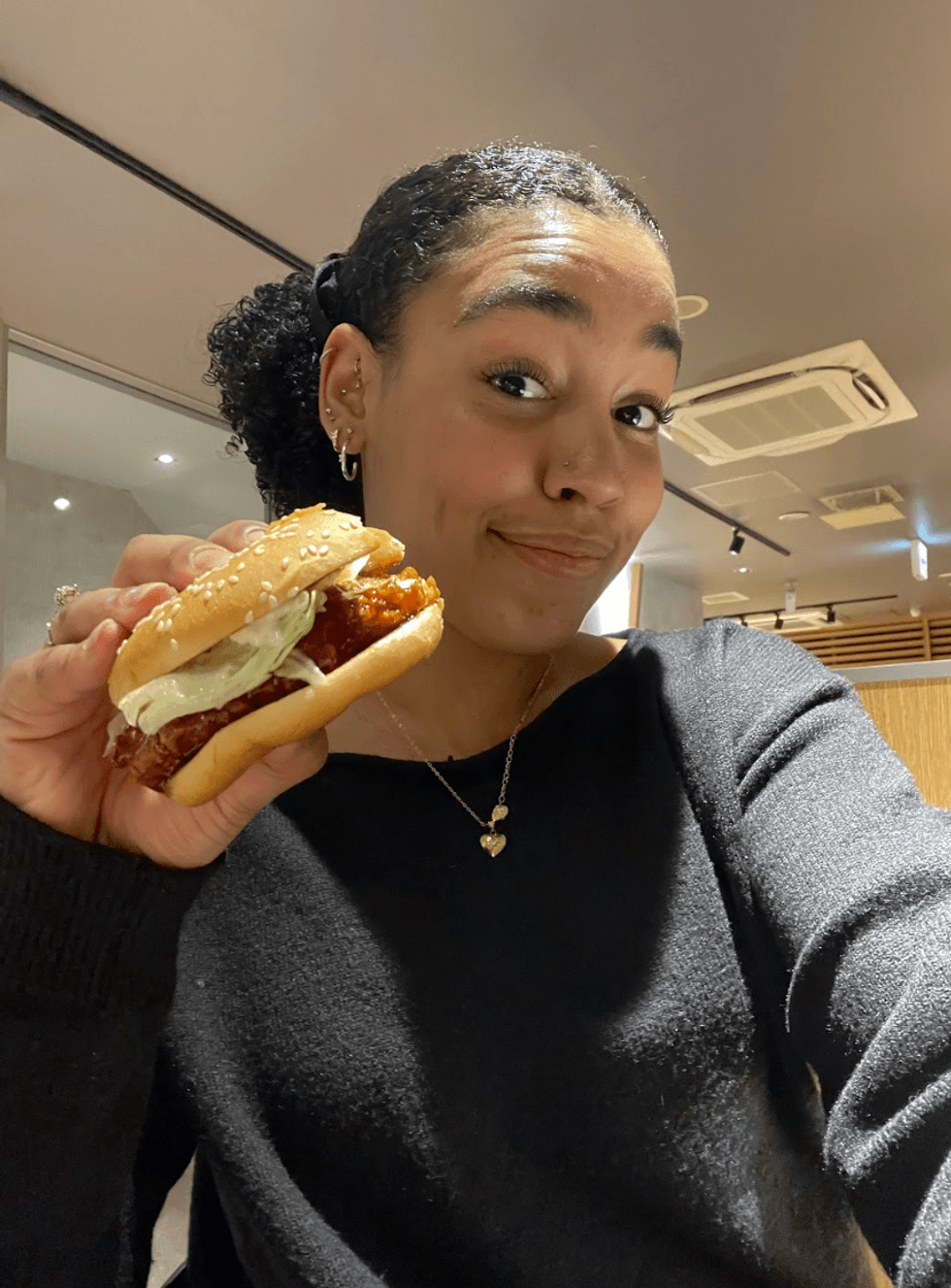 Person holding a McDonalds burger.