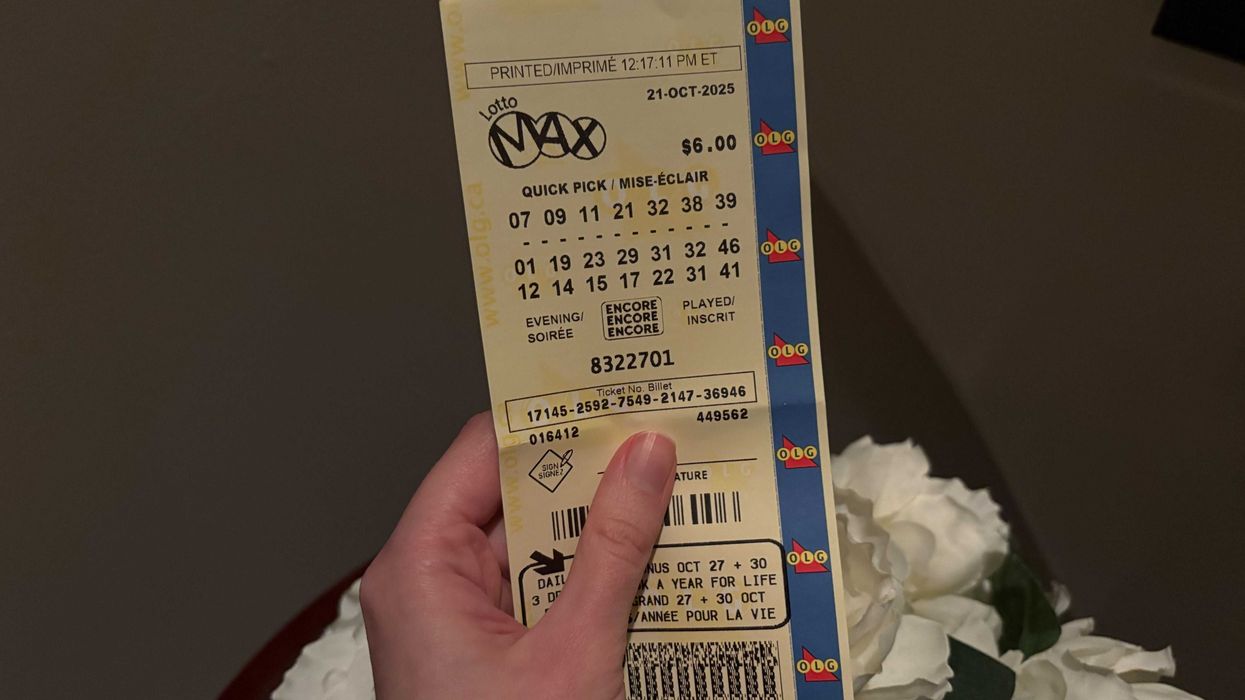 person holding an olg lotto max ticket