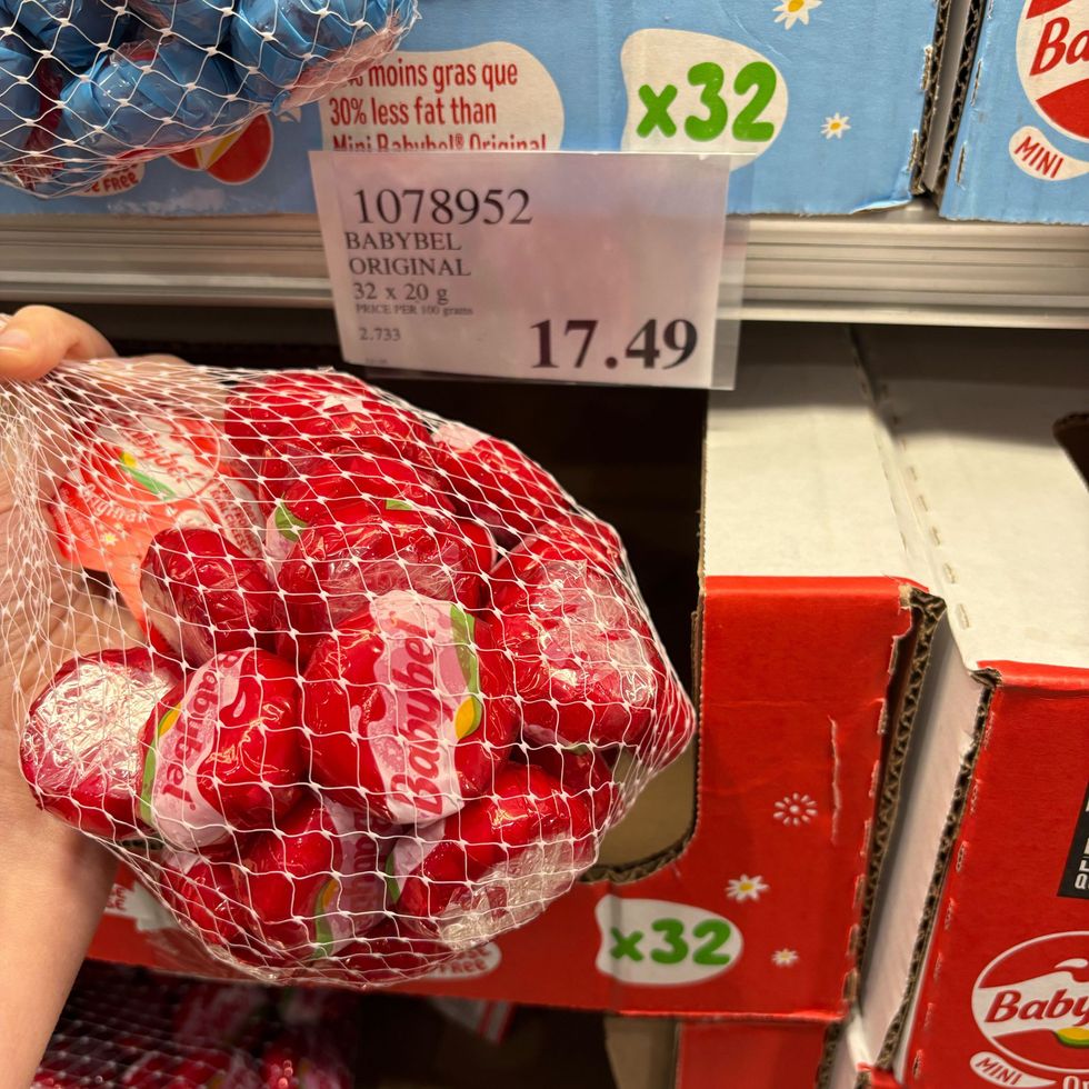 person holding bag of Babybel cheese at Costco