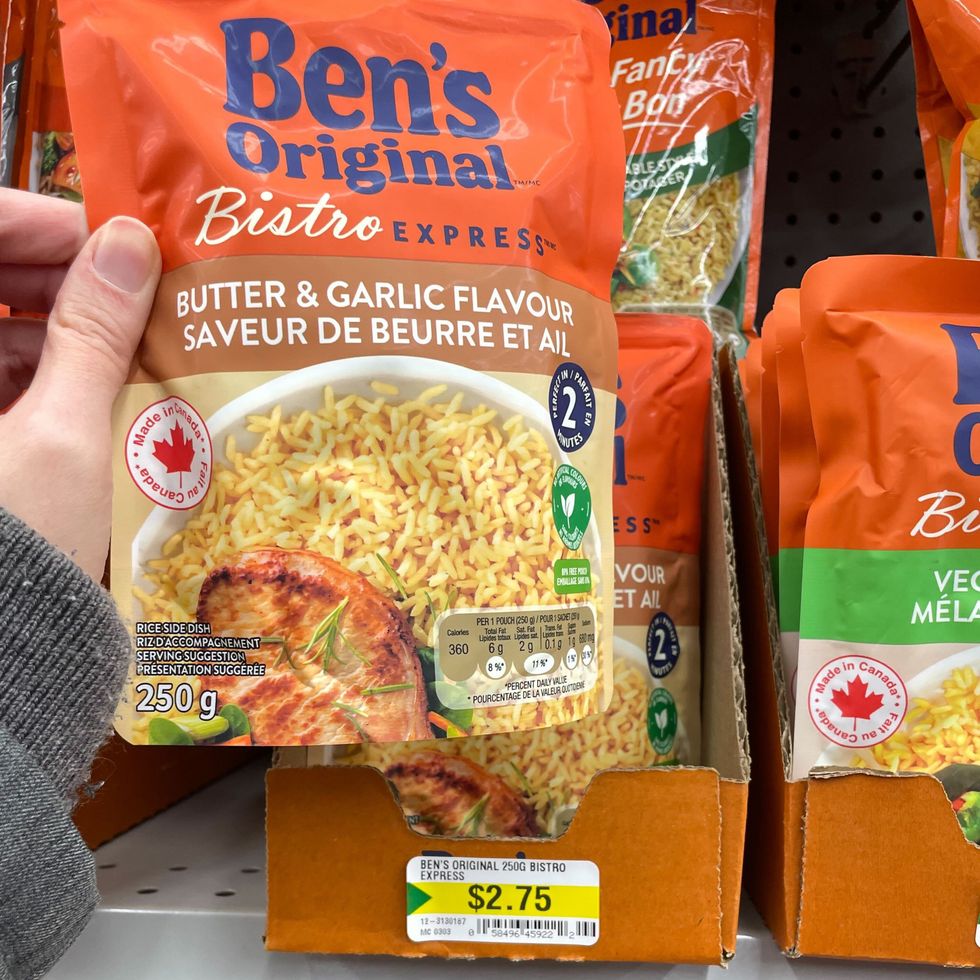 person holding bag of ben's original rice at dollarama