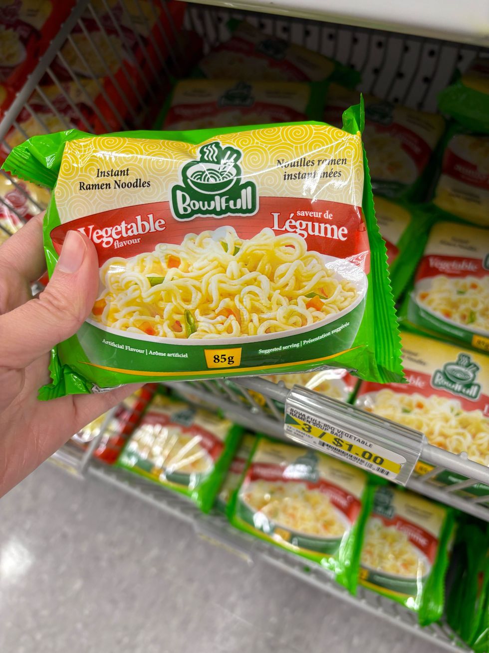 person holding bag of bowlfull instant noodles at dollarama