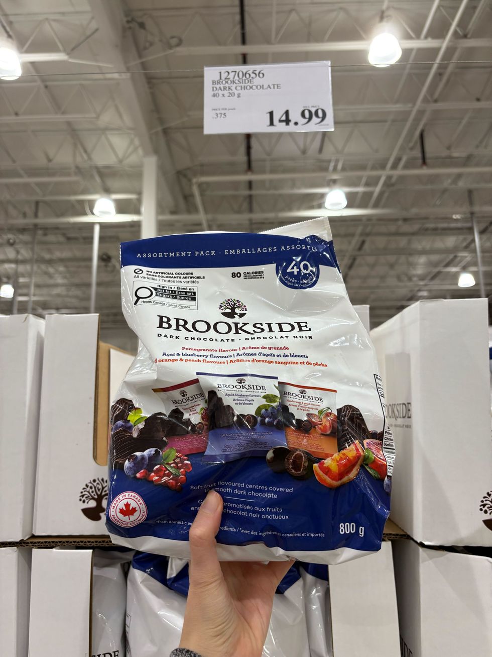 person holding bag of brookside chocolate covered fruit at costco