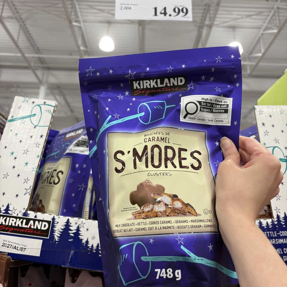 person holding bag of Kirkland Signature s'mores clusters at costco