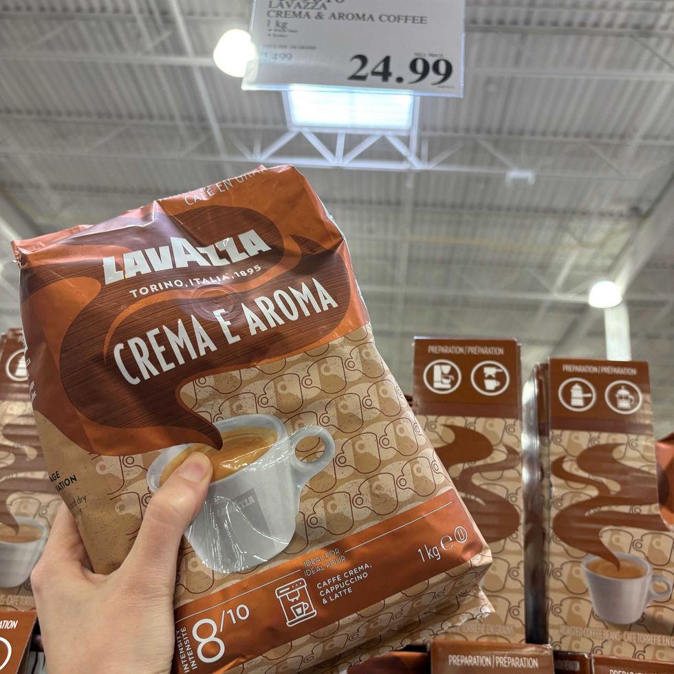 person holding bag of lavazza espresso beans at costco