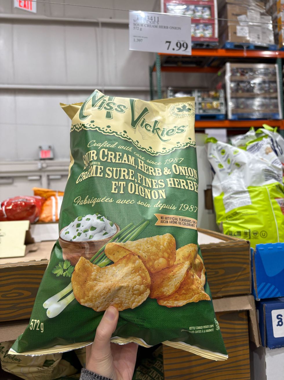 person holding bag of miss vickie's chips at costco