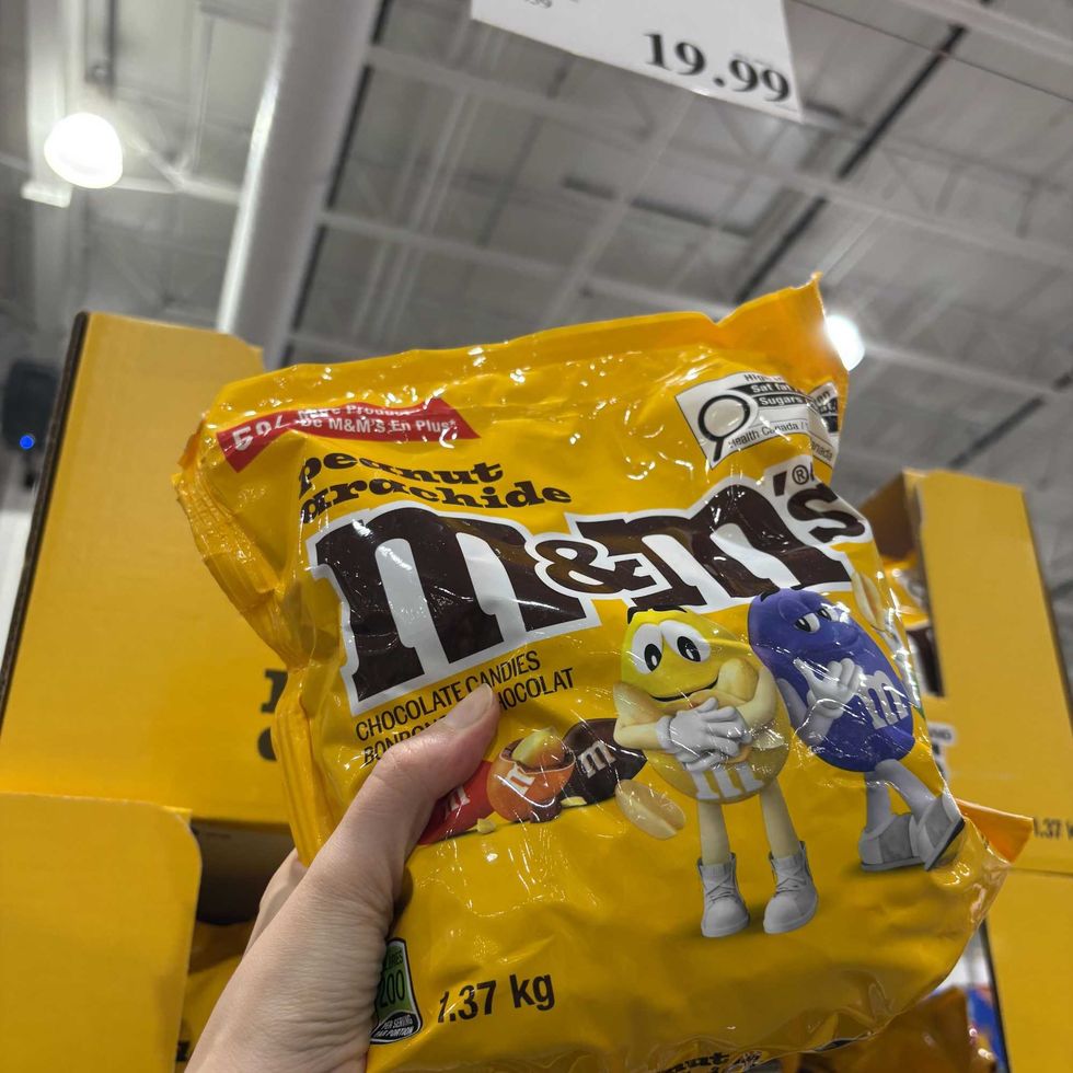 person holding bag of Peanut M&M's at costco