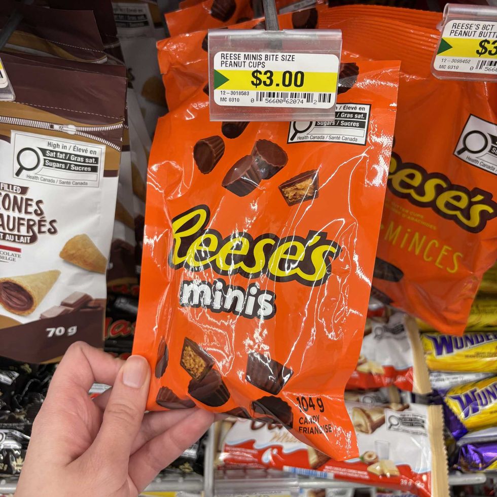 person holding bag of Reese's Minis at Dollarama