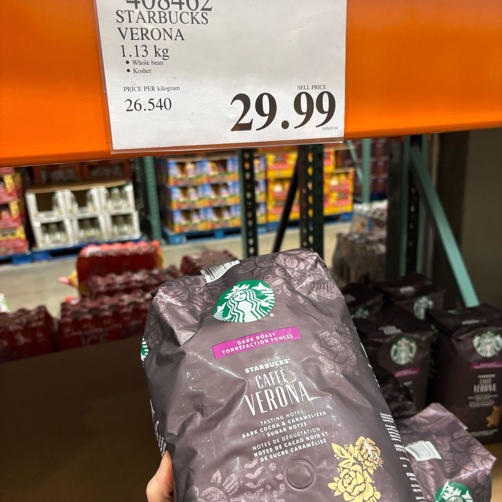 person holding bag of Starbucks Caffe Verona whole bean coffee at Costco